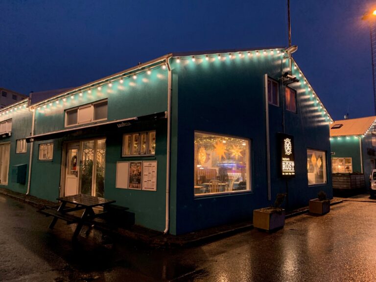 Rost cafe with blue exterior at twilight